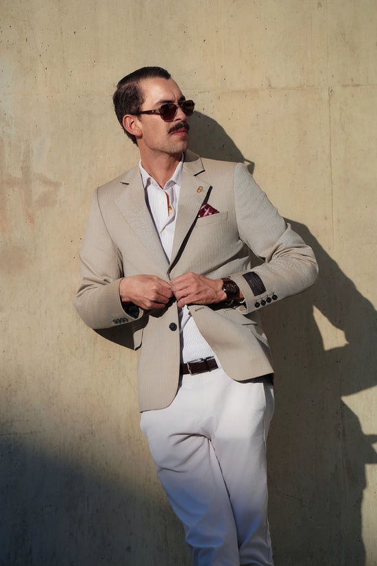 Model buttoning the Brummell x DGR Limited Edition motorcycle blazer, showcasing the tailored fit, Italian herringbone texture, and burgundy DGR pocket square.