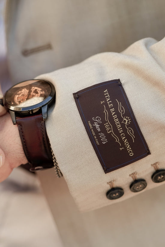 Close-up of the Vitale Barberis Canonico fabric label on the Brummell x DGR Limited Edition motorcycle blazer, showcasing premium Italian herringbone virgin wool.