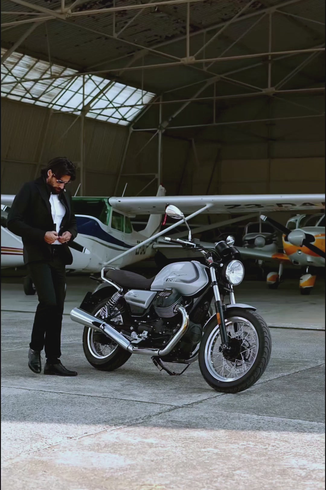 Motorcyclists wearing the Deep Black Brummell Blazer, zipping it up and taking off on his motorcycle.